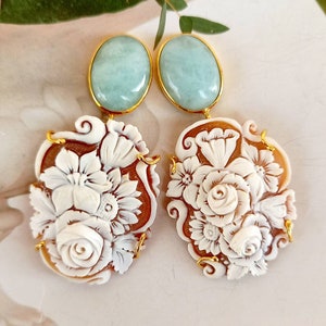 Aquamarine cabochon earrings and floral cameos.