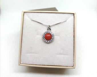 Red coral pendant and zircons.