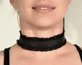 May include: A black leather choker with a black lace trim.