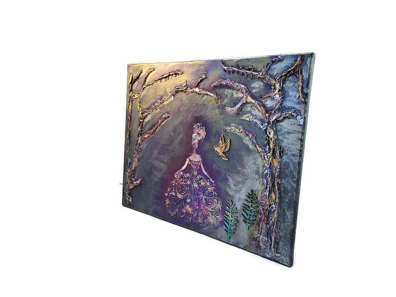May include: A textured canvas painting with a woman in a purple dress standing in a forest. The woman is surrounded by trees and a bird is flying above her. The painting has a whimsical and magical feel.