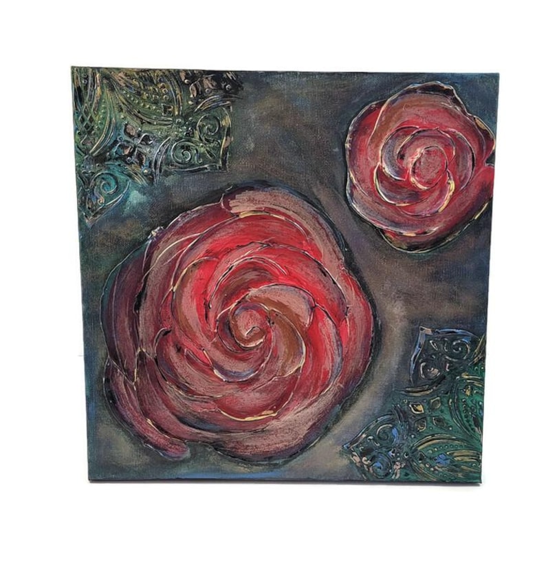 May include: Square canvas art featuring three red rose paintings with textured brushstrokes. The roses are set against a dark gray background with teal and gold decorative accents in the corners. The artwork is a close-up of the roses.