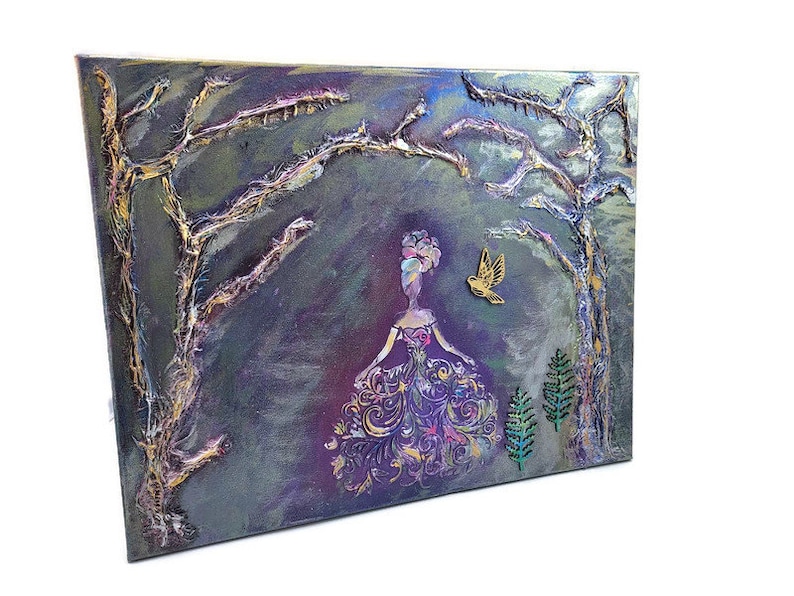 May include: A textured canvas painting with a purple, green, and gold color scheme. The painting depicts a woman in a flowing gown with a bird flying above her. The background features trees with gold branches.