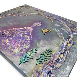 May include: Purple and gold abstract painting with a woman in a flowing dress and a bird in flight. The painting has a textured surface and is framed with a wooden frame.