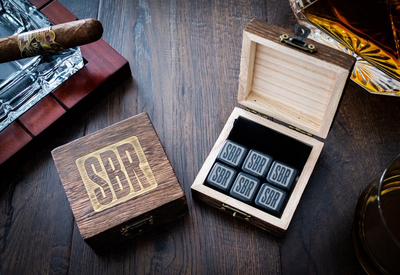 Pu&ograve; includere: Una scatola di legno con le iniziali "SBR" incise sul coperchio. La scatola contiene sei pietre per whisky quadrate nere con le stesse iniziali incise su ogni pietra.