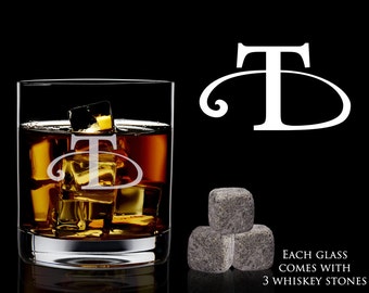 May include: A personalized whiskey glass with the letter "T" etched on the front. The glass is filled with whiskey and ice. Three gray whiskey stones are included.