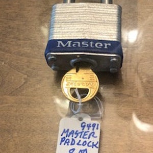 May include: A silver padlock with a blue band around the top. The padlock has the word "Master" printed on it in white letters. The padlock is accompanied by a brass key and a white tag with the text "9491 Master Padlock 8.00".
