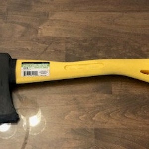 May include: A yellow-handled black axe with a wood-splitting blade. The axe has a rubberized grip and a safety guard.