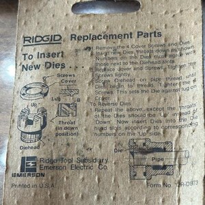 May include: Cardboard packaging for RIDGID replacement parts. The packaging includes instructions for inserting new dies, diagrams, and the Ridge Tool Subsidiary Emerson Electric Co. logo. The text "Printed in U.S.A." is visible.