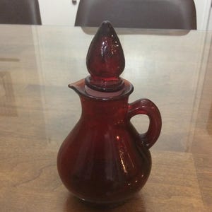 Avon ruby red glass pitcher Strawberry bath lotion decanter- &quot;Empty&quot; decanter- Pre-owned- Collectible .