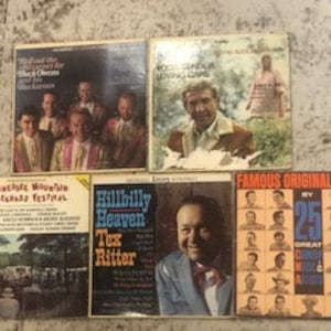 May include: Five vintage vinyl records with various country music artists. The records include "Walk On The Wild Side For The Black Chrome Buckaroos", "Red American Recording Artist", "Tennessee Mountain Bluegrass Festival", "Hillbilly Heaven Tex Ritter", and "Famous Original Hits By 25 Great Country & Western Stars".
