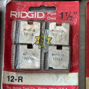 May include: RIDGID pipe dies, 1 1/2 inch, in a red and white package. The package includes four metal dies with the RIDGID logo and size information. The package also includes the text "12-R" and "The Ridge Tool Co., Elyria, Ohio, U.S.A."
