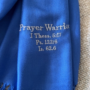 Puede incluir: Una estola de oración azul real con flecos en los bordes y texto bordado que dice "Prayer Warrior I Thess. 5:17 Ps. 122:6 Is. 62:6"
