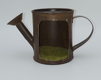 miniature rusty watering can with cut opening
