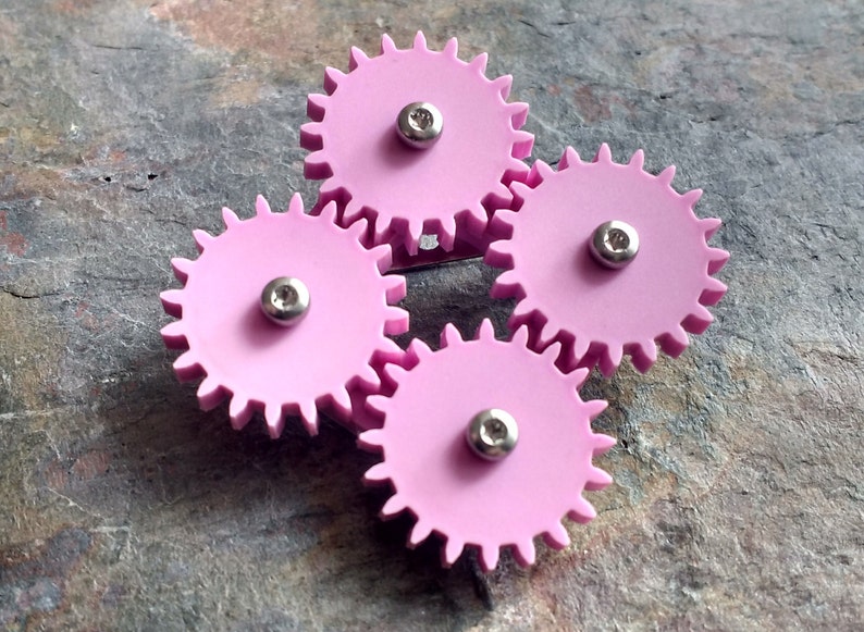 Pastel motion laser cut acrylic moving cog brooch. image 1