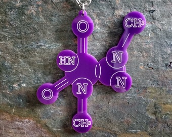 May include: Purple pendant necklace featuring a chemical structure with the text 'CH3', 'HN', 'N', and 'O'.