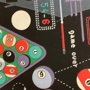 May include: Black fabric with a colorful billiards theme. The design includes a triangle of numbered billiard balls, individual balls, a cue stick, and the words "game over". The numbers 54-6 and 56-9 are also visible.