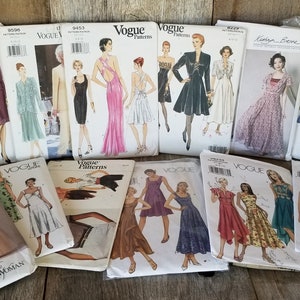 May include: A collection of vintage Vogue sewing patterns featuring various designs for dresses, tops, and skirts. The patterns are in various colors and feature different styles, including a wrap dress, a long skirt, and a short dress with a bow.