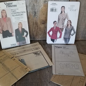 May include: Four Vogue sewing patterns for jackets. The patterns are on a wooden surface. The patterns are for sizes 12, 8-14, 6-14, and 12-20. The patterns are for two construction techniques, very easy, and tight fit.