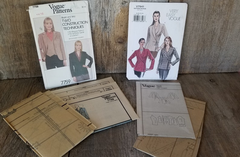 May include: Four Vogue sewing patterns for jackets. The patterns are on a wooden surface. The patterns are for sizes 12, 8-14, 6-14, and 12-20. The patterns are for two construction techniques, very easy, and tight fit.