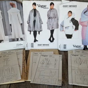 May include: A collection of vintage sewing patterns for coats and jackets. The patterns are from Vogue and Issey Miyake. The patterns are in various sizes and styles. The patterns are in good condition.
