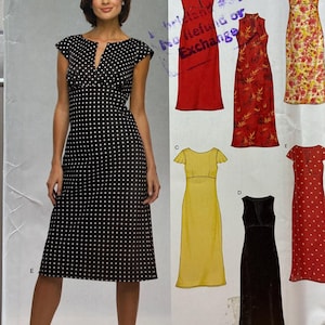 May include: A white ceramic mug with a black handle and the text "But First, Coffee" in a handwritten style. The mug is on a white surface. The mug is approximately 4 inches tall.