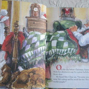 May include: A watercolour illustration of Father Christmas sleeping in a bed with a green and white checked blanket. The text reads, "On the day before Christmas, Santa was awakened from his afternoon nap by a great hullabaloo at the front door. He heard Mrs. Claus say, 'I'm sorry, you can't see Santa now. He's asleep and he needs his rest. He must travel the world tonight!'"