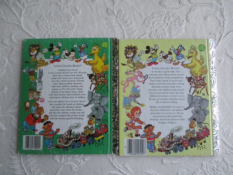 May include: Back covers of two Little Golden Books. The left book has a green cover with a train and various cartoon characters. The right book has a yellow cover with a train and various cartoon characters. The text on the back of the books reads "Little Golden Books".