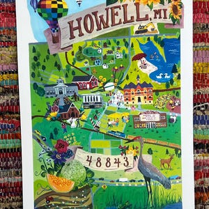 May include: A colorful illustrated map of Howell, MI, featuring a hot air balloon, sunflowers, and a sign that reads "Howell MI." The map includes a variety of landmarks, a lake with swans, and the zip code 48843.