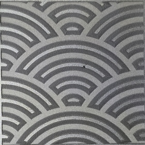 May include: A square tile featuring a repeating pattern of concentric semicircles in dark gray and light gray. The design consists of raised, textured dark gray arcs set against a smooth, lighter gray background, creating a geometric fan-like motif.
