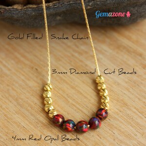 May include: Gold filled snake chain necklace with 3mm diamond cut beads and 4mm red opal beads.