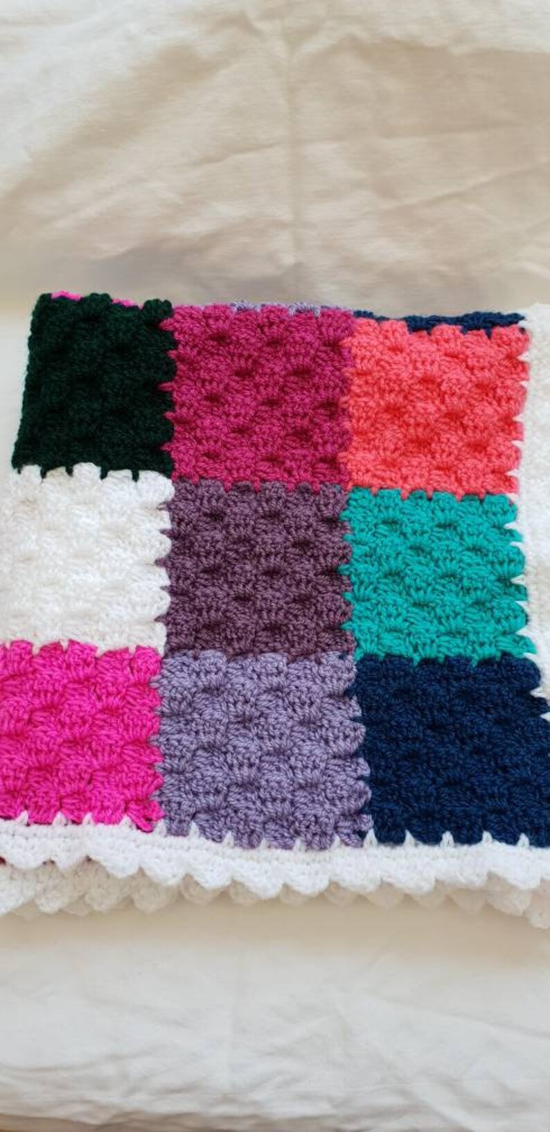 Handmade multi coloured patchwork crocheted baby blanket