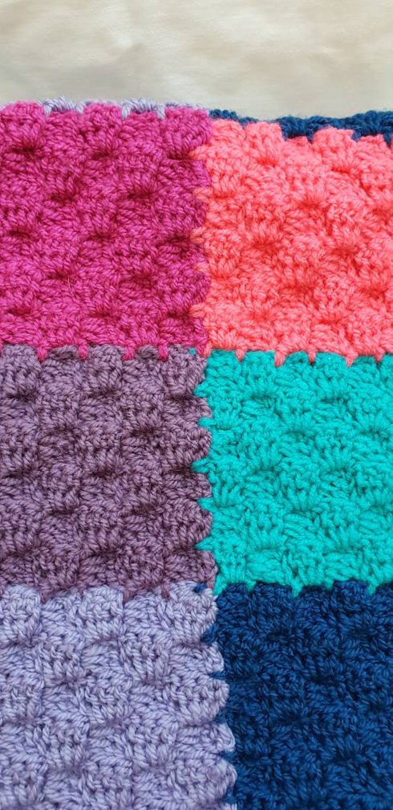 Handmade multi coloured patchwork crocheted baby blanket