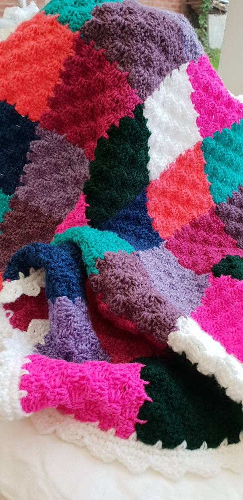Handmade multi coloured patchwork crocheted baby blanket