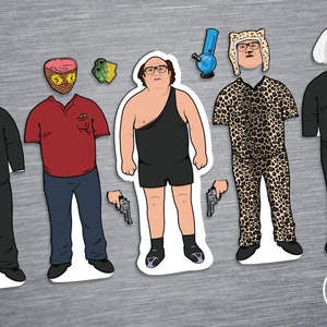 May include: Five paper cutouts of characters from the television show It's Always Sunny in Philadelphia. The characters are dressed in various outfits, including a tuxedo, a red polo shirt, a black one-piece swimsuit, a leopard print jumpsuit, and a black long-sleeved shirt. Each character is holding a gun in their hand.