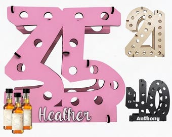 May include: A pink wooden display stand shaped like the number 35 with the name Heather printed on the base, featuring circular cutouts for miniature bottles. Additional stands shaped like the numbers 21 and 40 are shown in the background.
