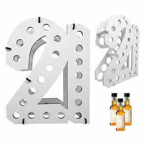 May include: A white wooden display stand shaped like the number 21, featuring multiple circular cutouts designed to hold small bottles. The structure is composed of two separate number pieces connected by horizontal supports, shown with three miniature bottles.