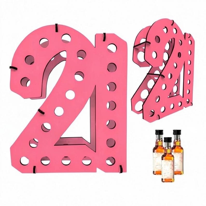 May include: A bright pink wooden display stand shaped like the number 21, featuring multiple circular cutouts designed to hold small bottles. The structure is shown from a front-facing view and an angled perspective, accompanied by three miniature glass bottles.