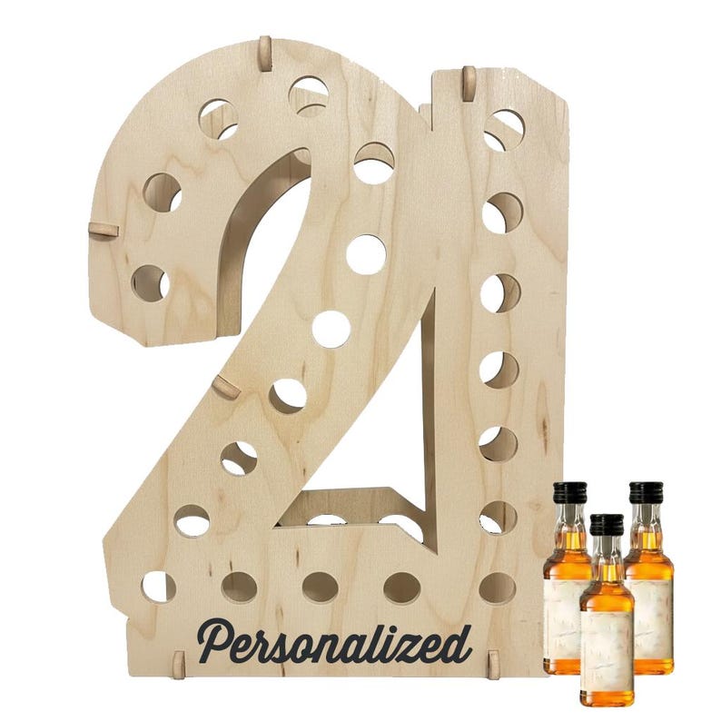 May include: A light-colored wooden display stand shaped like the number 21, featuring multiple circular cutouts for holding small bottles. The word Personalized is printed in black script at the bottom. Three small amber-colored glass bottles are included.