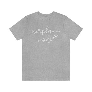 May include: A heather gray t-shirt with the text "airplane mode" in white cursive lettering and a small airplane icon.