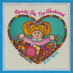 May include: A heart-shaped sticker with a cartoon girl surrounded by colorful candy. The sticker says "Ready for the Weekend" and "Jelly Bean" with a copyright of 1984 O.A.A., Inc.