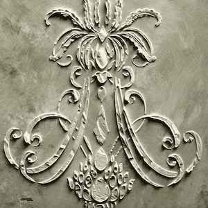 May include: A detailed, monochromatic relief sculpture featuring an ornate, symmetrical design. The artwork showcases stylized floral and geometric elements, including scrolling flourishes, diamond shapes, and a central, crown-like motif. The texture appears rough, with visible brushstrokes.