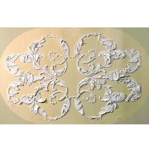 May include: White, raised floral design on a light yellow oval background. The design features four interconnected floral clusters with detailed leaf and swirl patterns, creating a decorative wall accent.