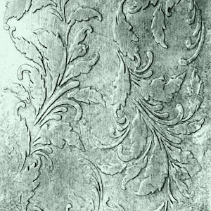 May include: A detailed, close-up view of a textured, gray surface with an embossed floral design. The design features stylized leaves and swirling patterns, creating a vintage, ornamental aesthetic. The image has a monochromatic, aged appearance.
