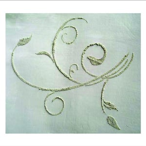 May include: A light green, textured floral design on a light green background. The design features swirling lines, spirals, and leaf-like shapes, creating a decorative, organic pattern. The texture of the design appears to be raised.