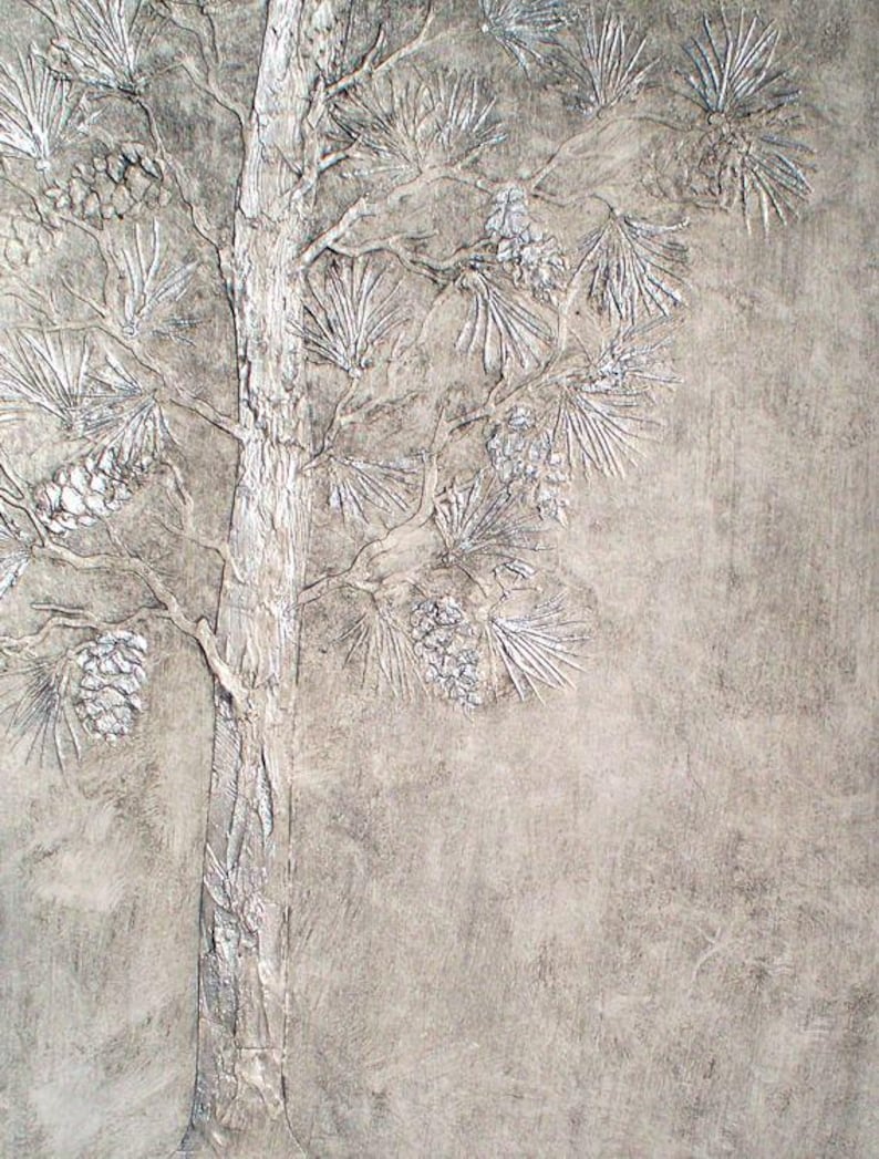 May include: A textured, monochromatic artwork featuring a detailed relief of a pine tree. The tree's trunk and branches are visible, with textured pine needles and pine cones. The artwork is in shades of gray and white, creating a natural, rustic aesthetic.