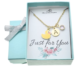 May include: A gold necklace with a yellow rubber duck charm, a letter 'A' charm, and a pink crystal charm. The necklace is in a blue gift box with a white card that says "Just for You".