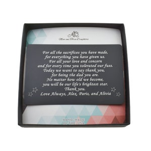 May include: A black card with a silver inscription in a black box with a patterned blue and pink interior. The inscription reads: "For all the sacrifices you have made, for everything you have given us. For all your love and concern and for every time you tolerated our fuss. Today we want to say thank you, for being the dad you are. No matter how old we become, you will be our life's brightest star. Thank you. Love Always, Alex, Paris, and Alivia". The box also has a label that reads "HAND-MADE IN-THE-USA".