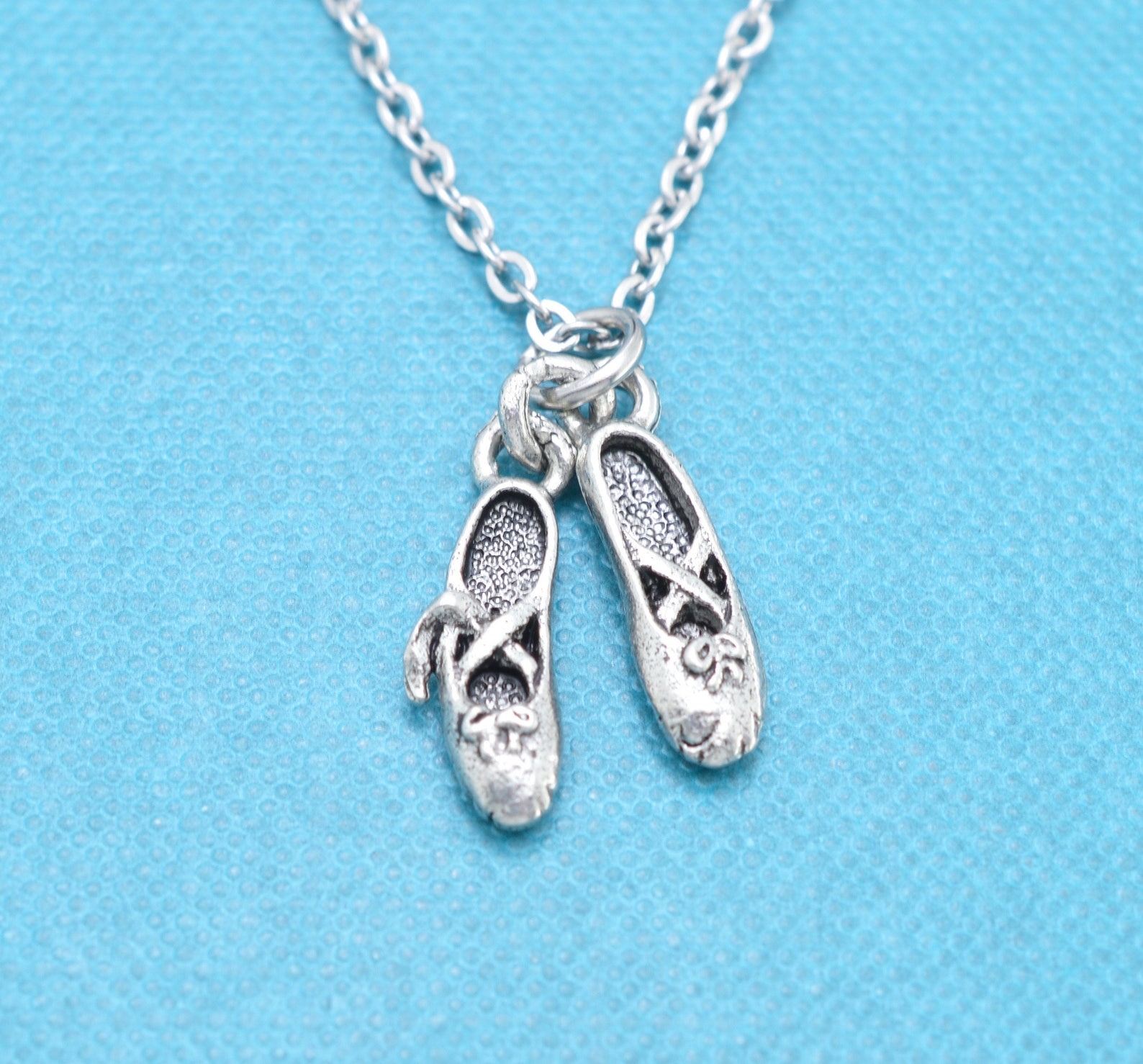 little girl's ballet slippers necklace in silver pewter on a 14