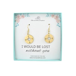 May include: Gold compass earrings in a gift box with the text "I would be lost without you".