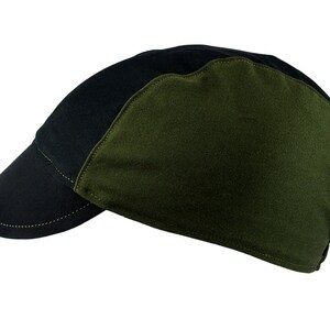 May include: A black and green baseball cap with a curved brim. The cap is made of a soft, durable fabric.